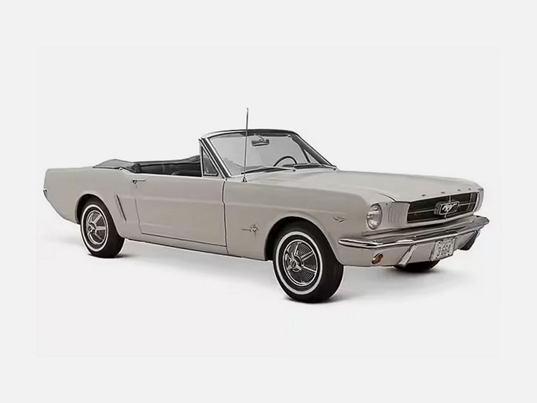 A classic white convertible sports car — the first Mustang produced with a serial number