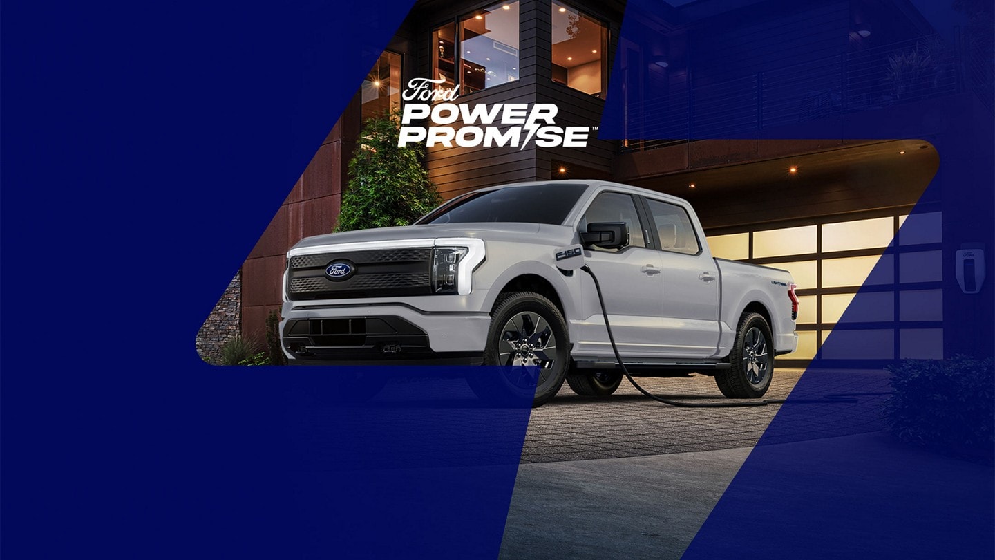 A Ford F-150 Lightning? being charged outside a home in the driveway
