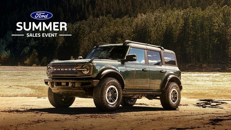 A 2024 Ford Bronco® Badlands® SUV parked near a forest stream