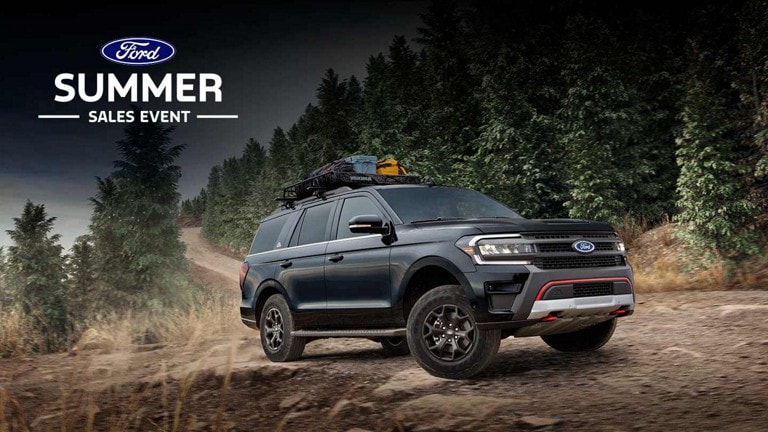 A 2024 Ford Expedition® being driven on a forest dirt road
