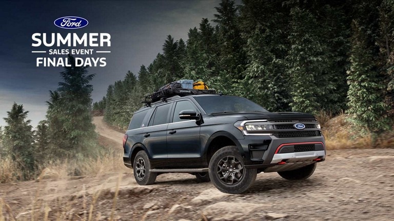 A 2024 Ford Expedition® being driven on a forest dirt road