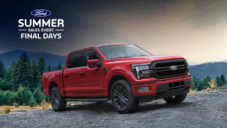 A 2024 Ford F-150® Lariat parked on a dirt road with mountains in the background