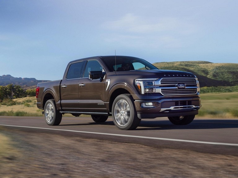 A gorgeous F-150 pickup truck driving on a rural road