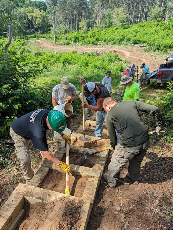 People building steps along a trail.