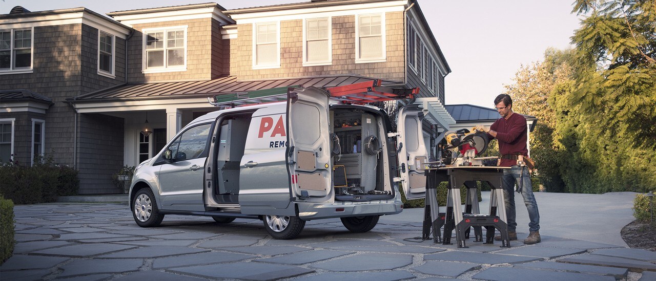 A contractor working from the back of a transit connect cargo van