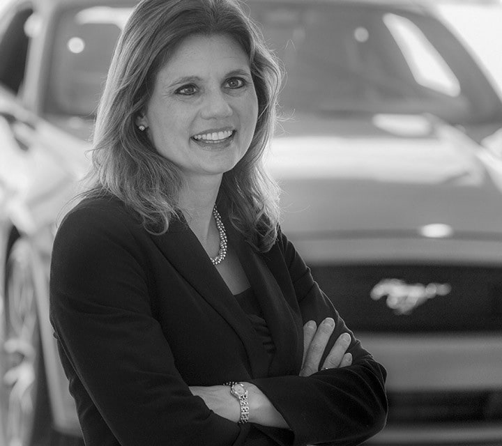 A close-up black and white portrait of Dr. Cynthia Flanigan, a woman innovator at Ford. Rollover of the photo enlarges her photo slightly. Clicking her photo takes you to her professional bio.