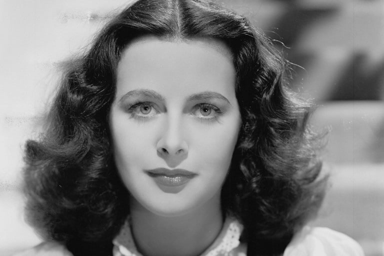 We see a black and white portrait of auto innovator Hedy Lamarr.