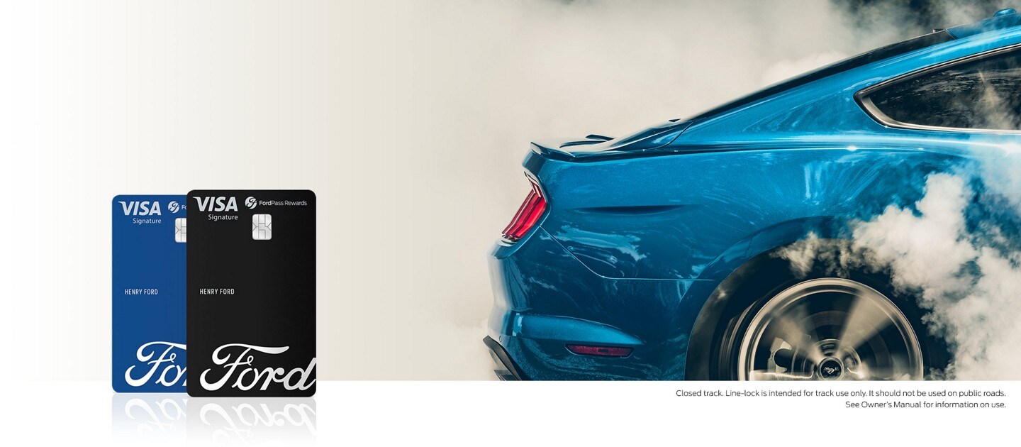 Two FordPass Rewards Visa cards nest to a shot of the rear end of a Ford Mustang
