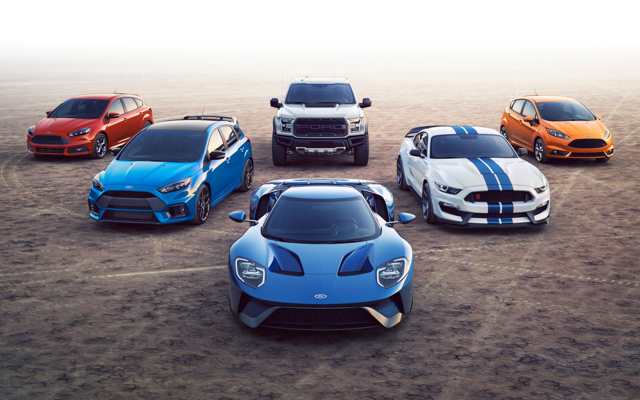 Group of Ford performance vehicles parked on dry lake bed.