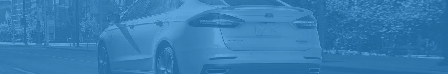 Back end of 2020 Ford® Fusion shown on a blue background