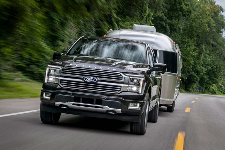 2024 Ford F-150® XLT in Agate Black pulling a camper trailer