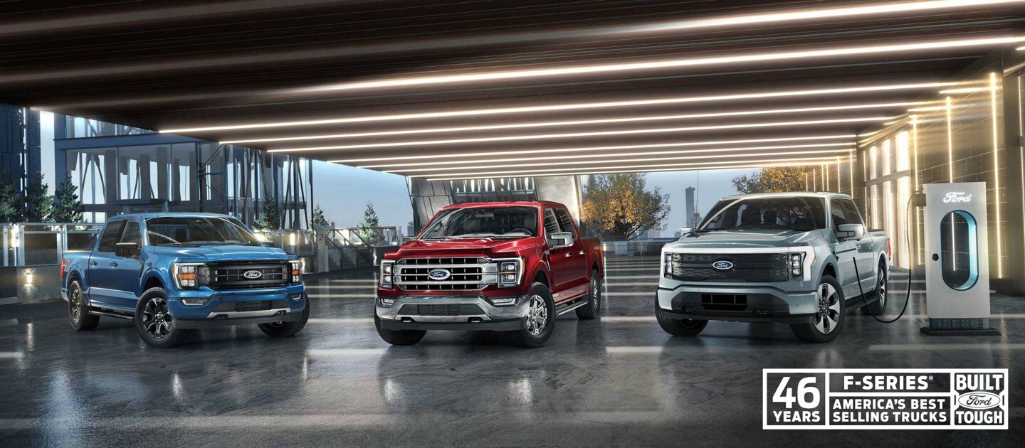 Ford F-150® in Atlas Blue, F-150 PowerBoost™ hybrid in Rapid Red and an F-150 Lightning™ in Iced Blue SIlver