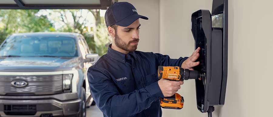 An installer finishes work on a Ford Charge Station Pro