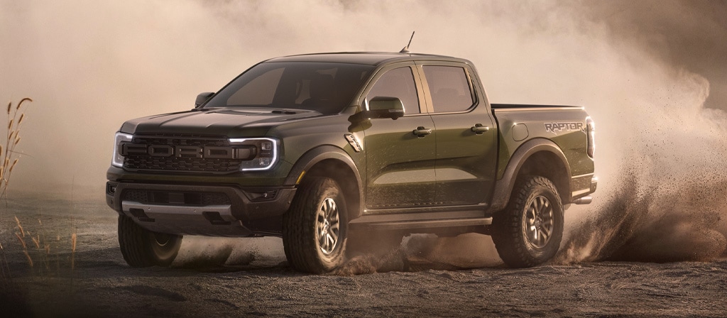 A 2025 Ford Ranger® pickup is being driven off kicking up dust
