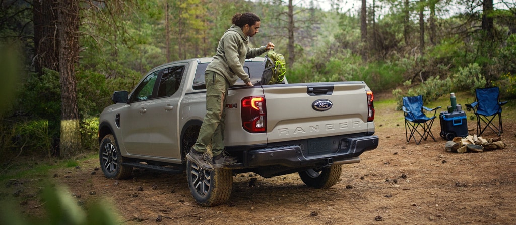 A person using the box side step feature on the 2025 Ford Ranger®
