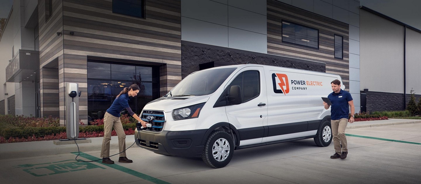 A woman is shown charging a 2023 Ford E-Transit™ vehicle