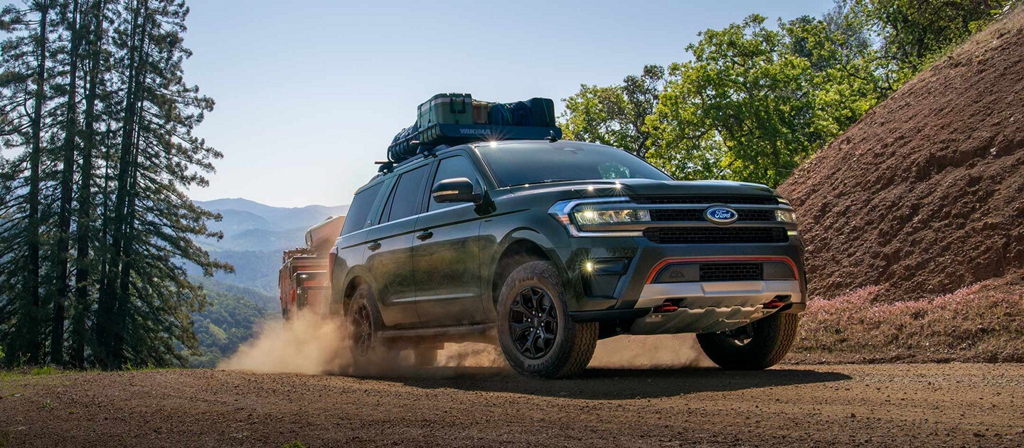 A 2024 Ford Expedition® driving over rugged, sandy terrain