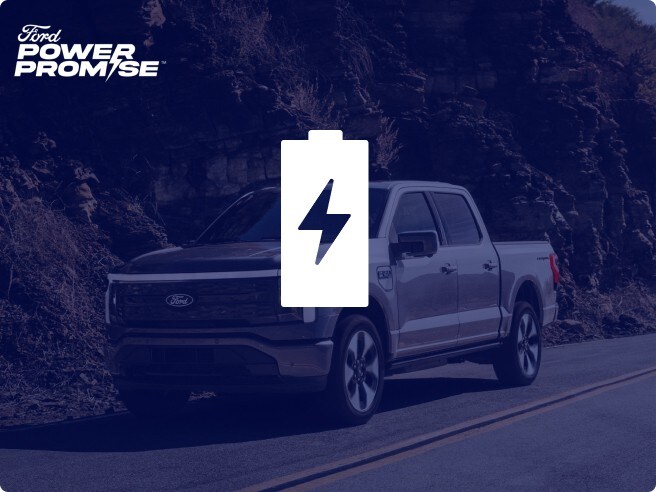 A 2024 Ford F-150 Lightning driving down the road