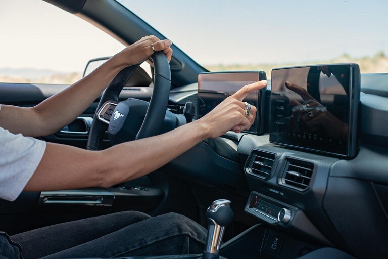 Person driving a 2025 Ford Mustang® model with a view of the interior