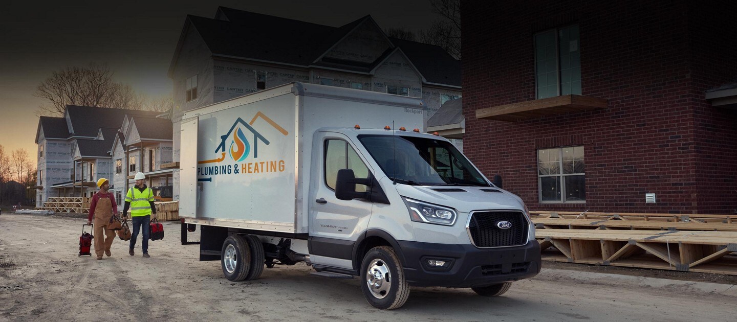 A 2023 Ford Transit® Chassis Cab with two people at a construction site