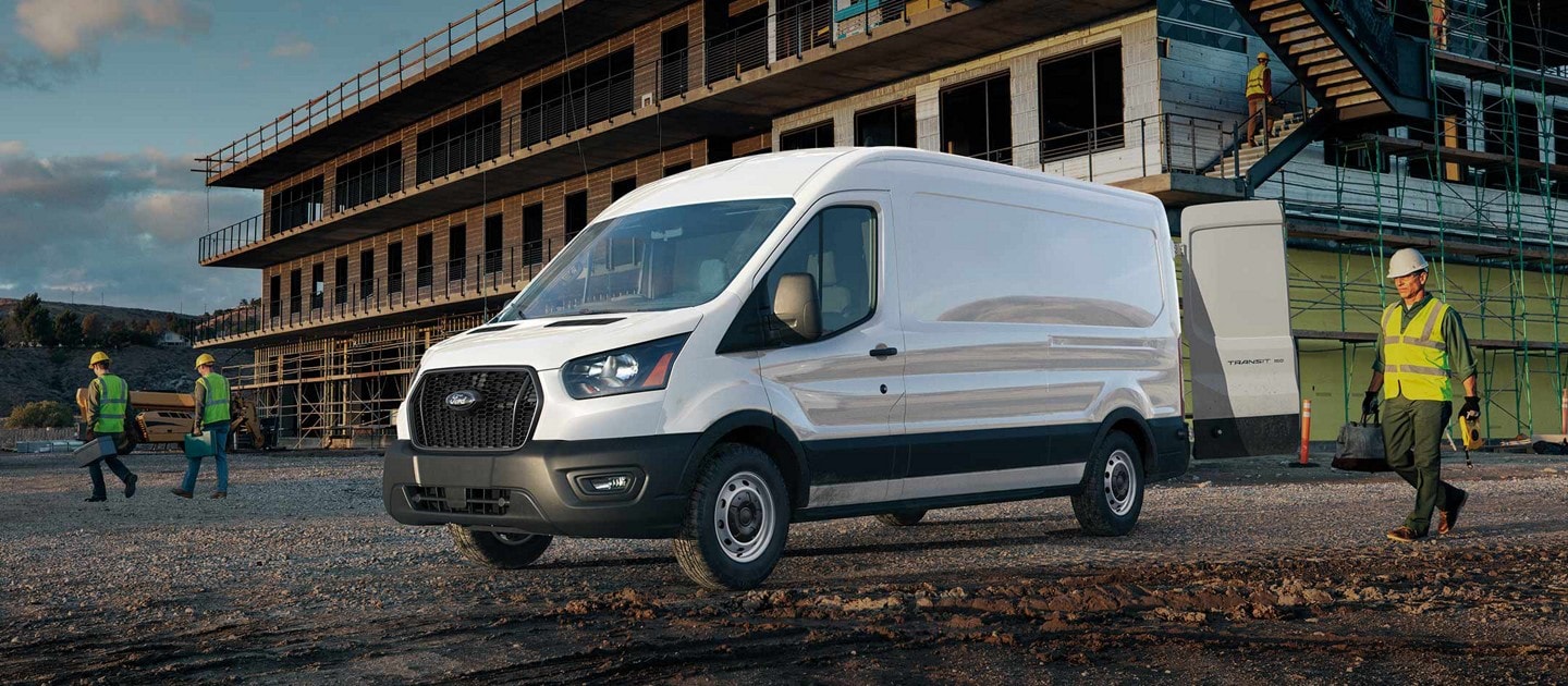 2024 Ford Transit® van parked in front of construction site with workers nearby