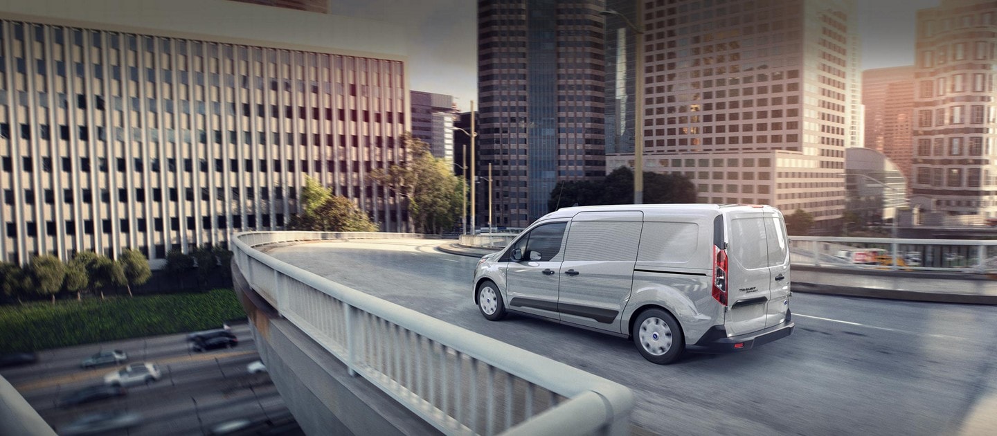 2023 Ford Transit Connect Cargo Van in Silver being driven on an expressway ramp